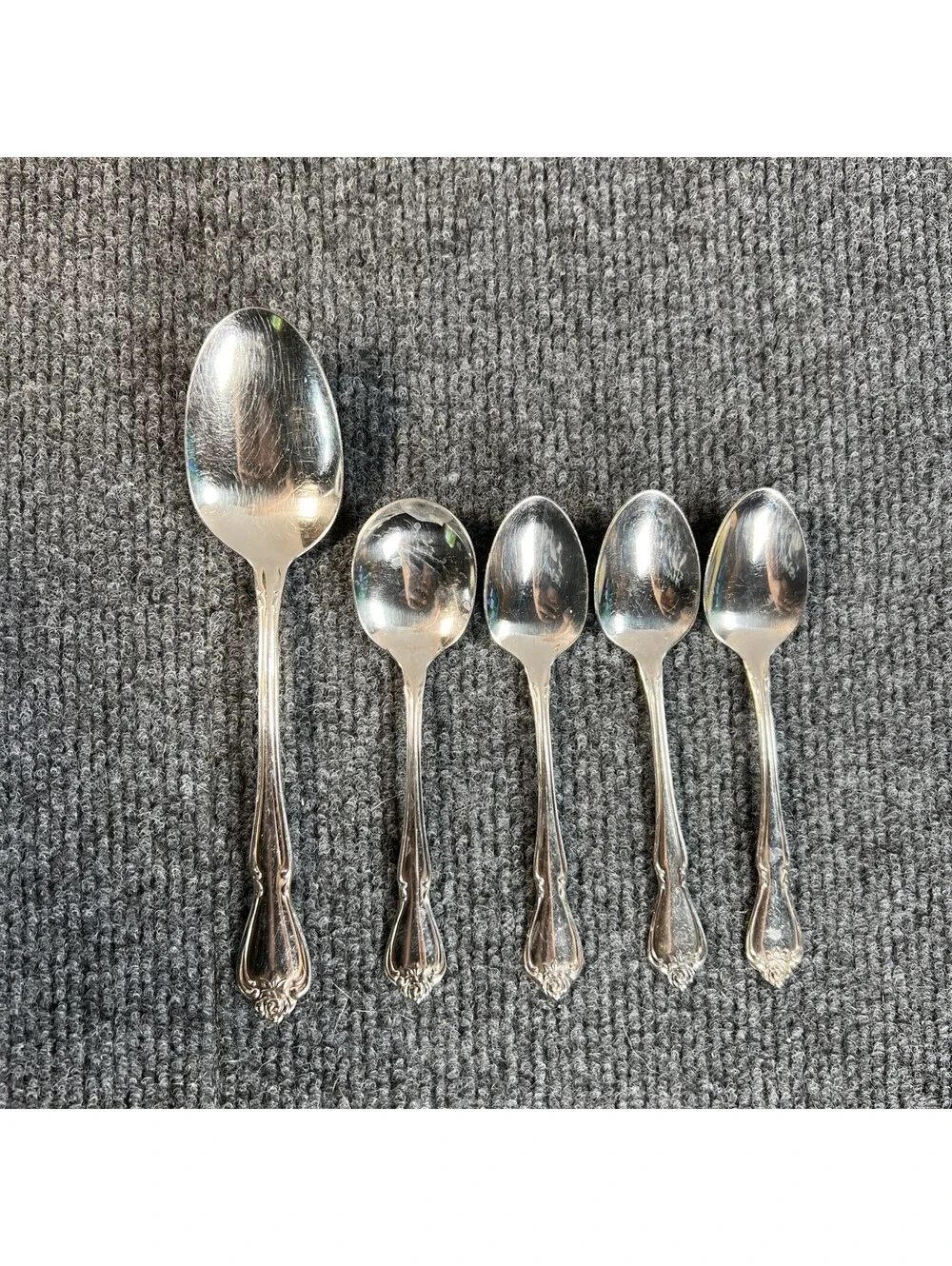 oneida stainless flatware  3 Teaspoons, 1 Soup Spoon(?) 1 Serving Spoon